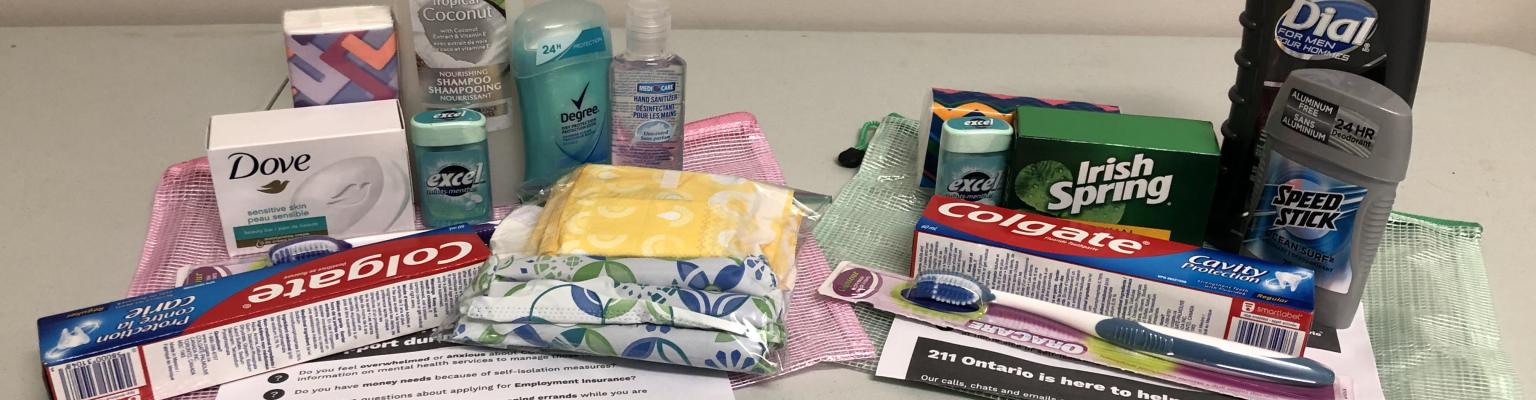 wellness kits containing basic hygiene products like shampoo, soap, deodorant, socks, and local support resources 